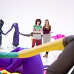 Two adults standing in the middle of a inflatable art installation and admiring the work