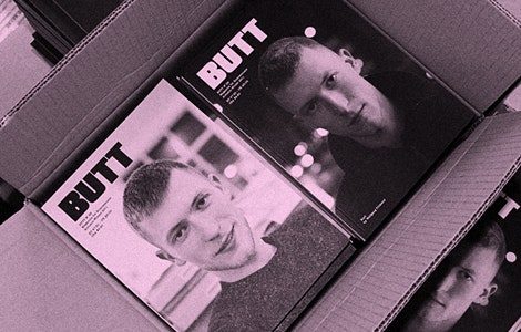 An open cardboard box with black and white covers off the magazine 