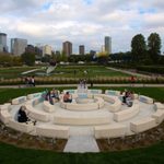 The Walker-commissioned piece, titled Okciyapi (2021), is the first public artwork by a Native artist to be sited in the Garden. Both a gathering place and participatory work, the sculpture is composed of rings of seating elements surrounding a central water feature.