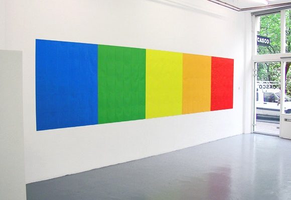 large rainbow colored squares on a lit white wall in the Walker Art Center