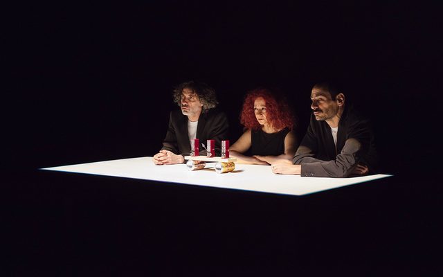 Three people sitting at a table