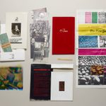 Display of historical playbills, pictures, a popsicle stick, and page from the New York Times
